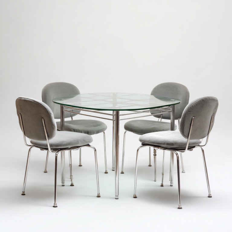 Juego de comedor moderno con mesa redonda de cristal y 4 sillas tapizadas en terciopelo gris.